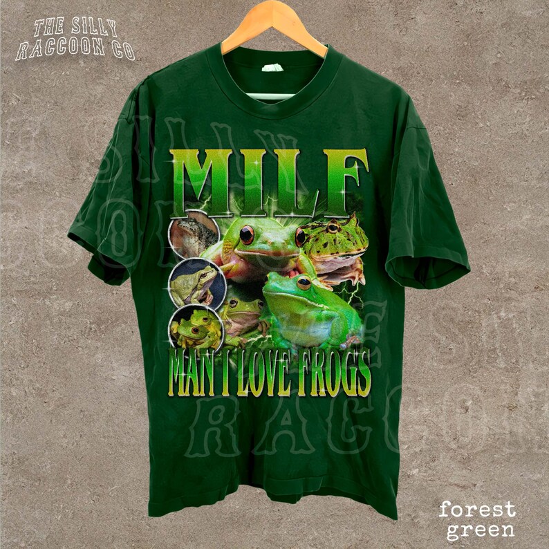 A green t-shirt with a graphic design featuring a frog and the text "MILF MAN I LOVE FROGS" printed on it.