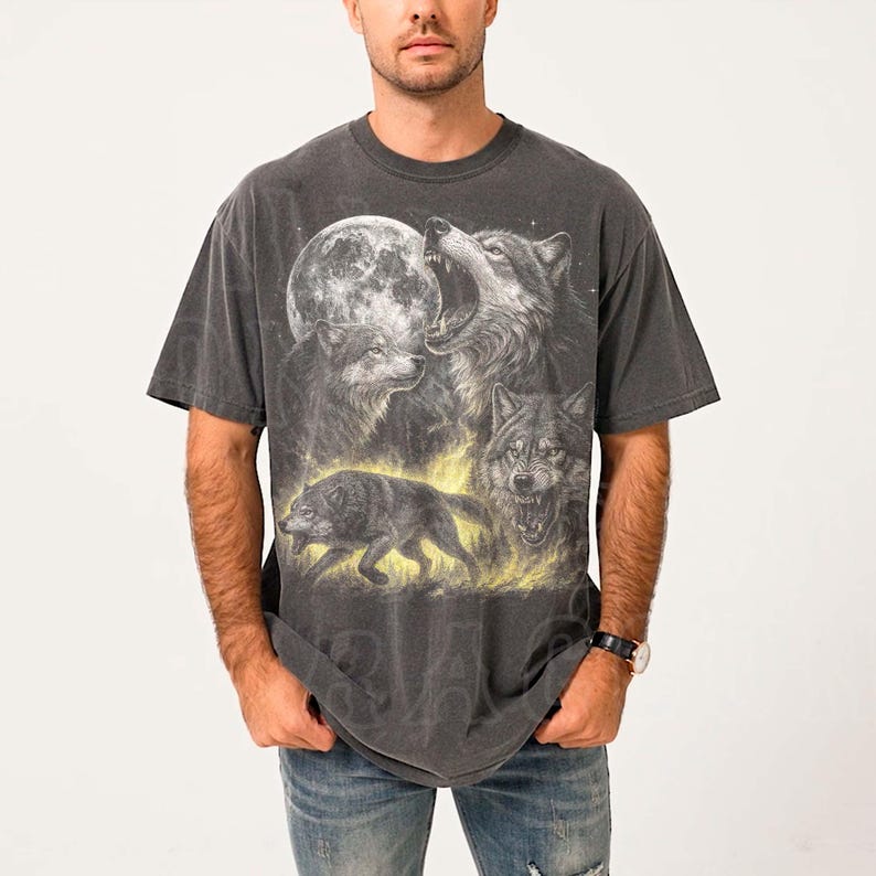 A man wearing a gray t-shirt with a graphic design of a pack of wolves.