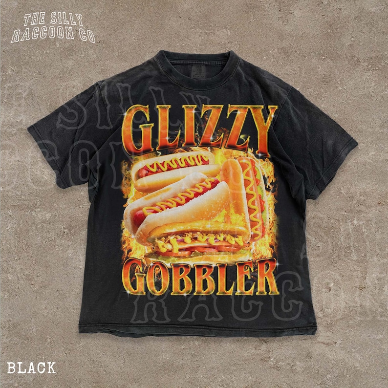 A black t-shirt with a graphic design featuring two hot dogs on a bun, surrounded by flames.