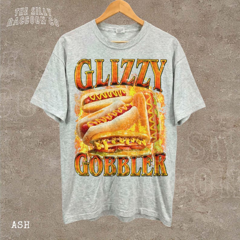 A grey t-shirt with a graphic design featuring two hot dogs and the text "GLIZZY GOBBLER" printed on it.