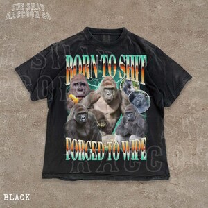 The image is a black t-shirt with a graphic design featuring a group of gorillas and the text "BORN TO SHIT FORCED TO WIPE" printed on it.