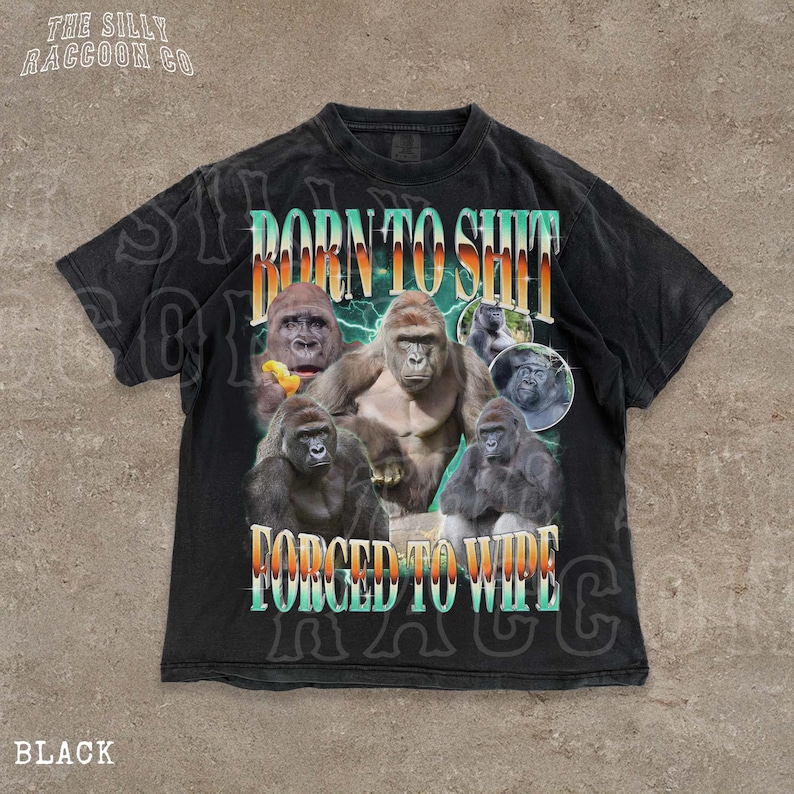 The image is a black t-shirt with a graphic design featuring a group of gorillas and the text "BORN TO SHIT FORCED TO WIPE" printed on it.