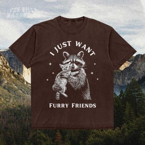 a brown t - shirt with a picture of a raccoon hugging another ra