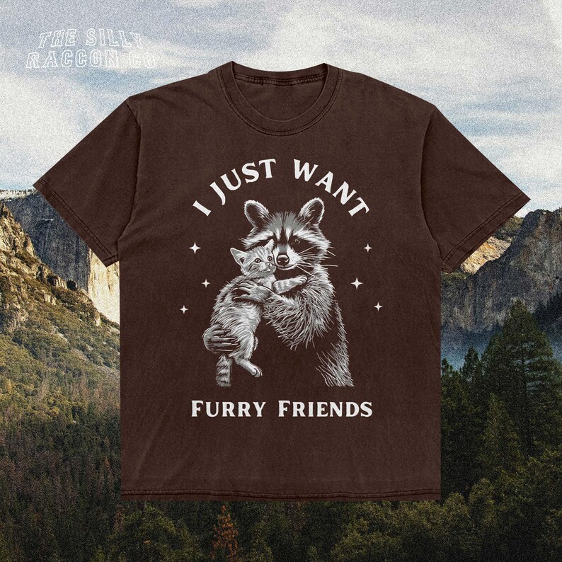 a brown t - shirt with a picture of a raccoon hugging another ra