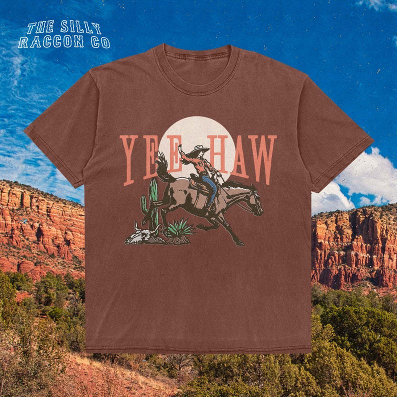 a t - shirt with a cowboy riding a horse in the desert