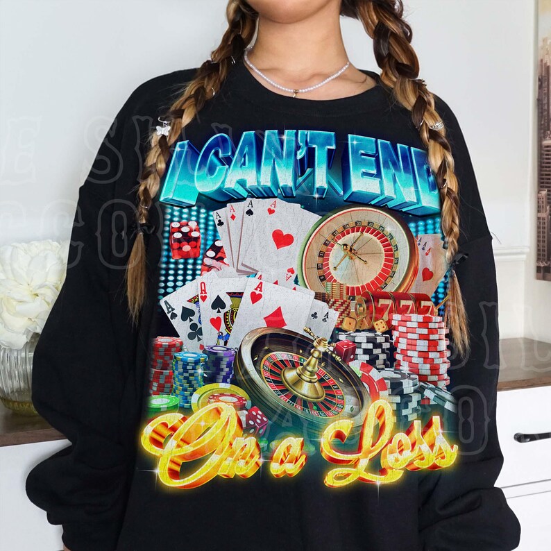 A person wearing a black sweatshirt with a graphic design featuring various casino-related elements, including playing cards, a roulette wheel, and stacks of poker chips.