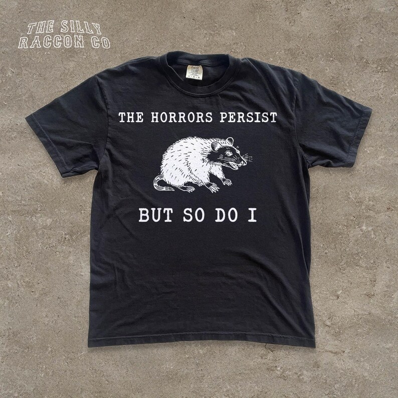 A black t-shirt with a graphic design and text printed on it.