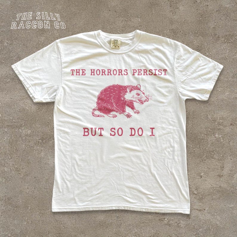 A white t-shirt with a graphic design and text printed on it.
