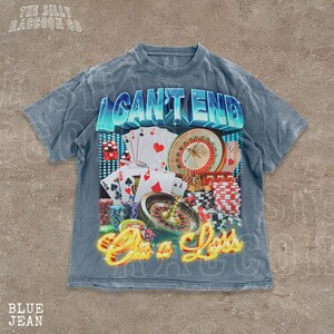 A t-shirt with a graphic design featuring various casino-related elements, such as playing cards, poker chips, and a roulette wheel. The text on the t-shirt reads "I CAN'T END" and "On a Loss".