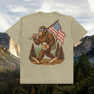 a t - shirt with a picture of a bigfoot holding a flag