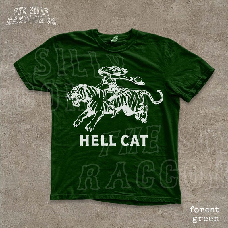 A green t-shirt with a white graphic design depicting a person riding a tiger.