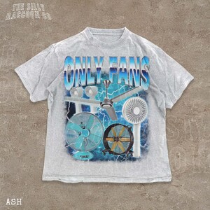 A gray t-shirt with a graphic design featuring various fans and the text "ONLY FANS" printed on it.