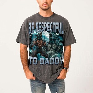 A man wearing a gray t-shirt with a graphic design featuring two werewolves and the text "BE RESPECTFUL TO DADDY".