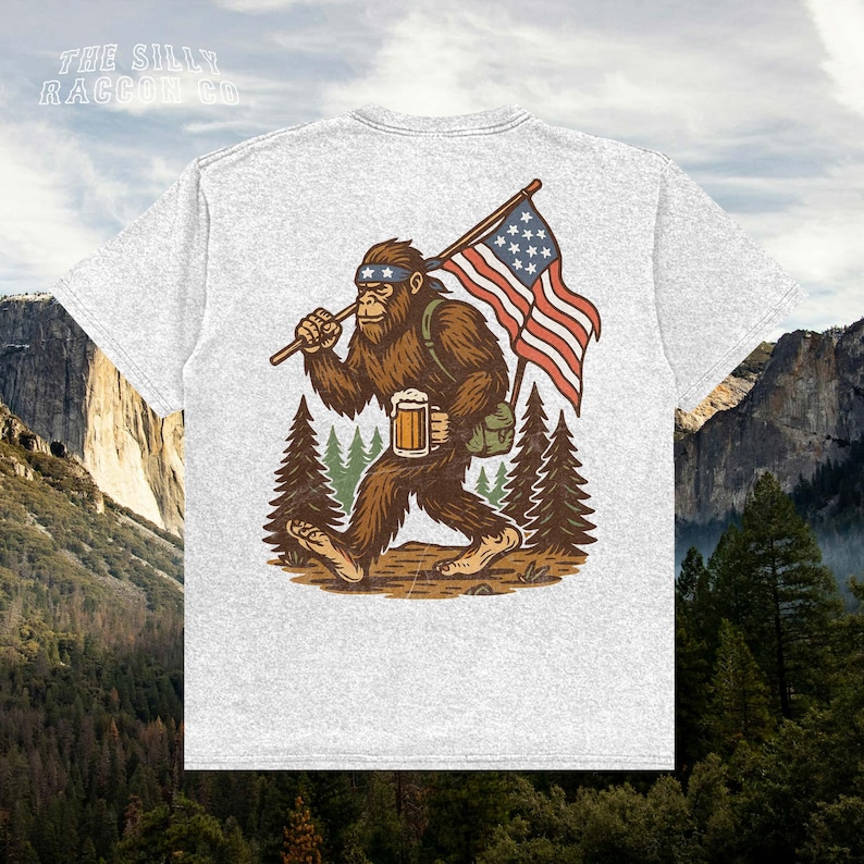 a t - shirt with a picture of a bigfoot holding a flag