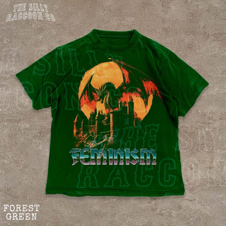 A green t-shirt with a graphic design depicting a dragon and a castle, along with the word "Feminism" printed on it.