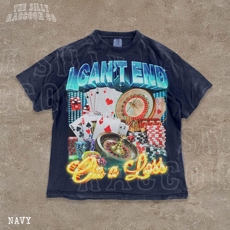 A navy blue t-shirt with a graphic design featuring various casino-related elements, including playing cards, a roulette wheel, and stacks of poker chips. The text on the t-shirt reads "I CAN'T END ON A LESS THAN 500 CHARACTERS".