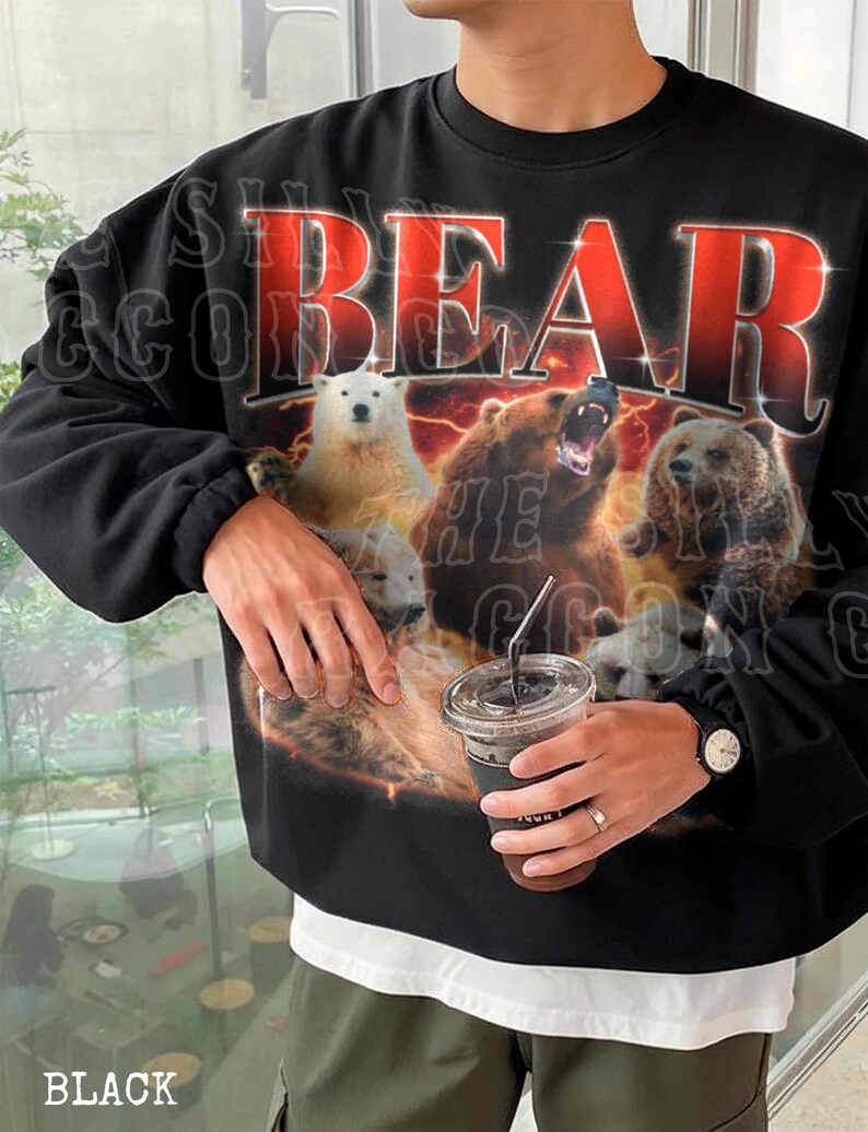 A person wearing a black sweatshirt with a graphic design featuring a polar bear and three other bears.