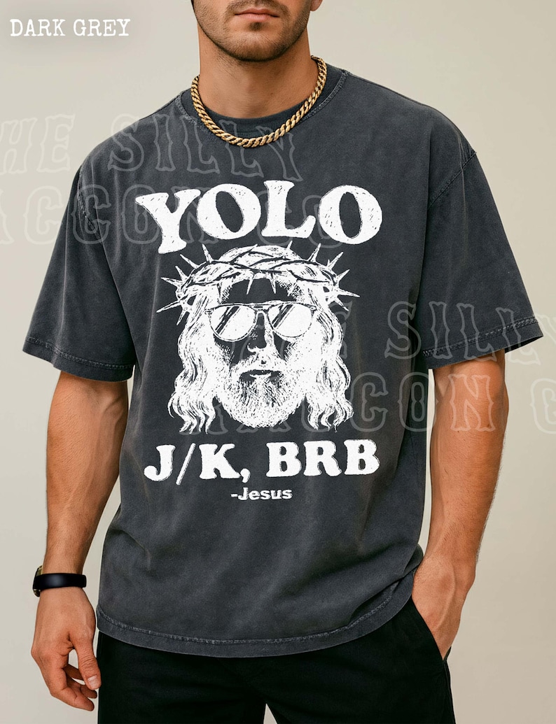 A man wearing a black t-shirt with a graphic design featuring a stylized depiction of Jesus and the text "YOLO J/K, BRB - Jesus".