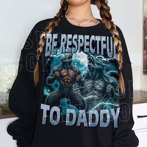 A person wearing a black sweatshirt with a graphic design featuring two werewolves and the text "BE RESPECTFUL TO DADDY".