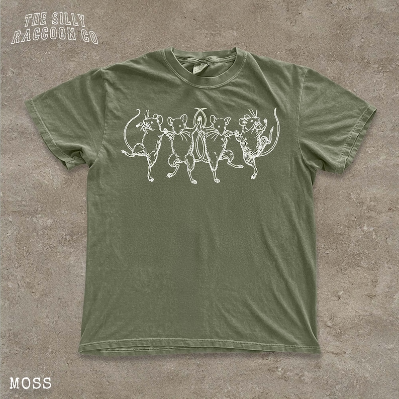 A green t-shirt with a white graphic design depicting a group of cats or mice.