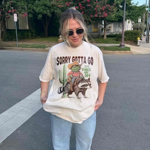 a woman wearing a t - shirt with a picture of a cat on it