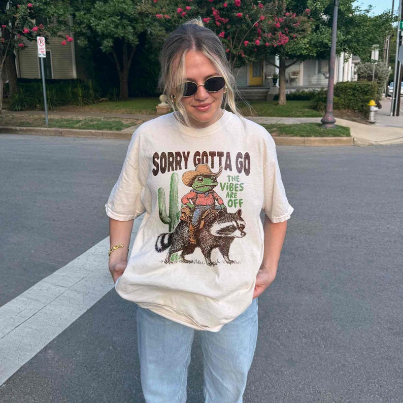 a woman wearing a t - shirt with a picture of a cat on it