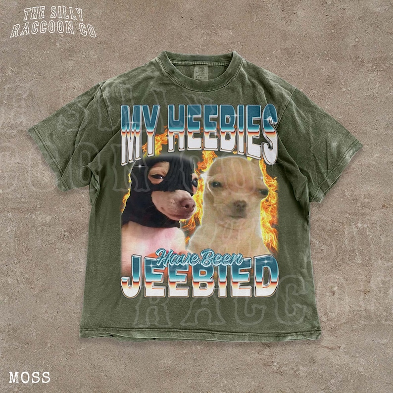 A t-shirt with a graphic design featuring two dogs, one black and one tan, with flames and text overlaying the image.
