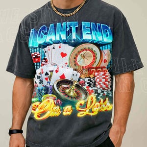A man wearing a t-shirt with a graphic design featuring casino elements, including a roulette wheel, playing cards, and poker chips.