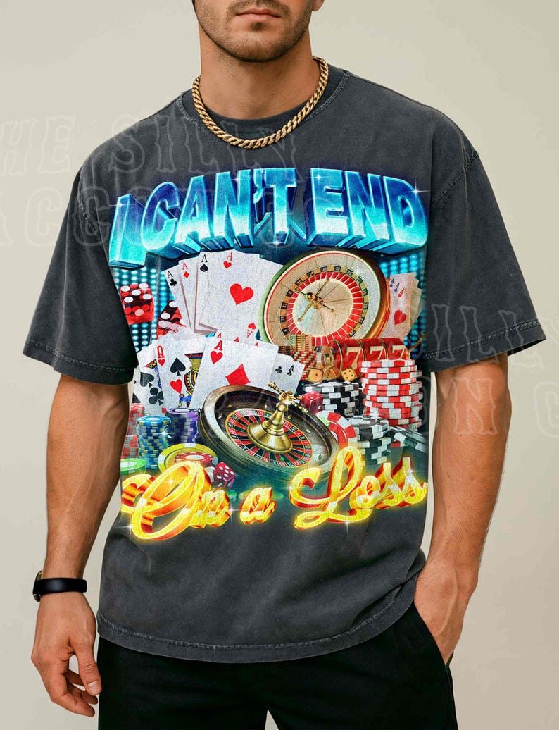 A man wearing a t-shirt with a graphic design featuring casino elements, including a roulette wheel, playing cards, and poker chips.