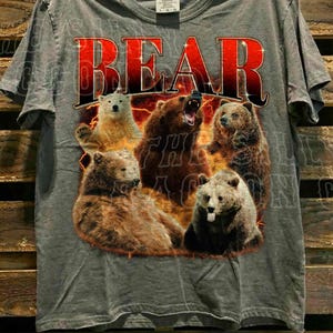 A grey t-shirt with a graphic design featuring a group of bears in various poses.