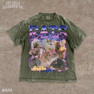 A t-shirt with a graphic design featuring a group of rats and cheese, along with the text "RATS Cheese Gang" printed on it.