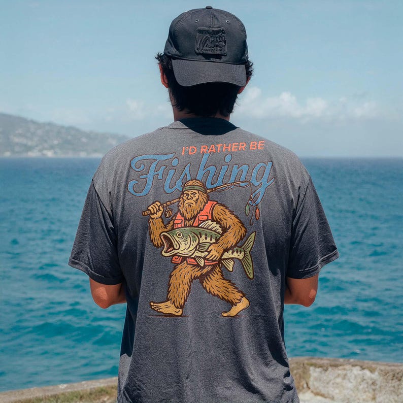 a man standing on top of a cliff next to the ocean