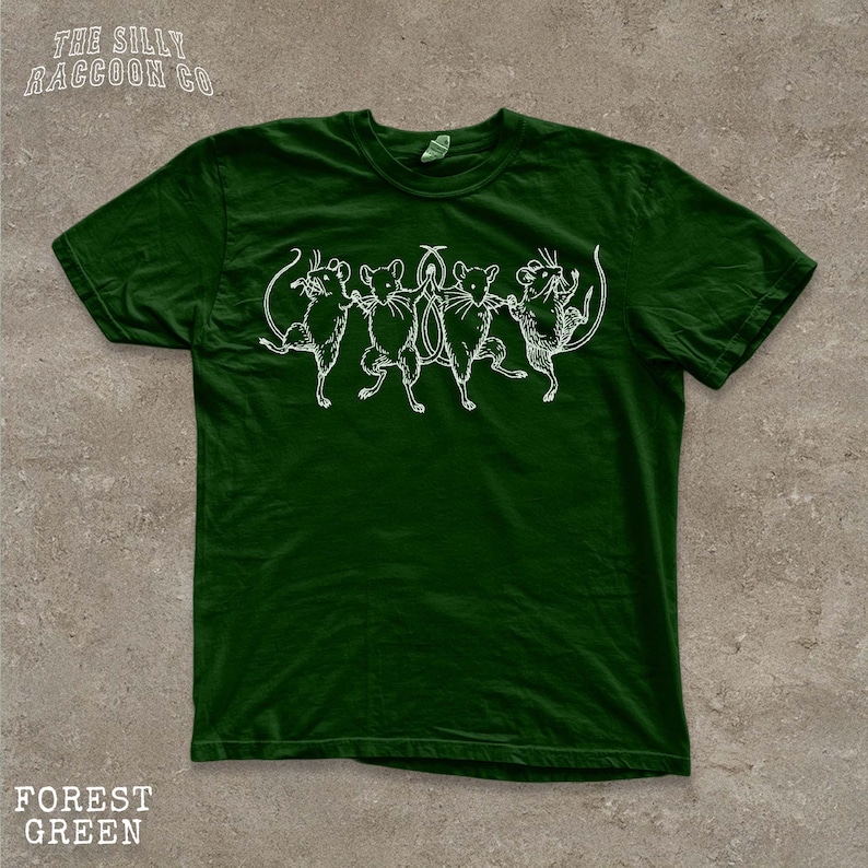 A green t-shirt with a white illustration of a group of mice dancing together.