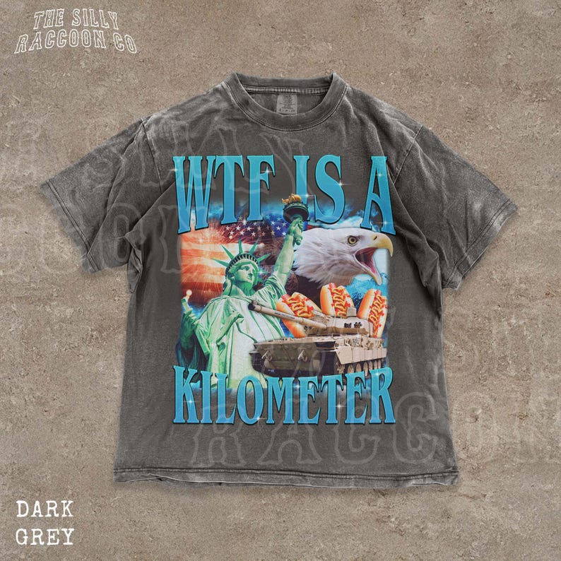 A gray t-shirt with a graphic design featuring the Statue of Liberty and an eagle, along with the text "WTF IS A KILOMETER" and "Dark Grey".