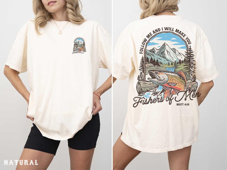 A woman wearing a white t-shirt with a graphic design on the back. The design features a mountain landscape with a fish and includes the text "Follow me and I will make you" and "Fishers of men" along with a Bible verse reference.