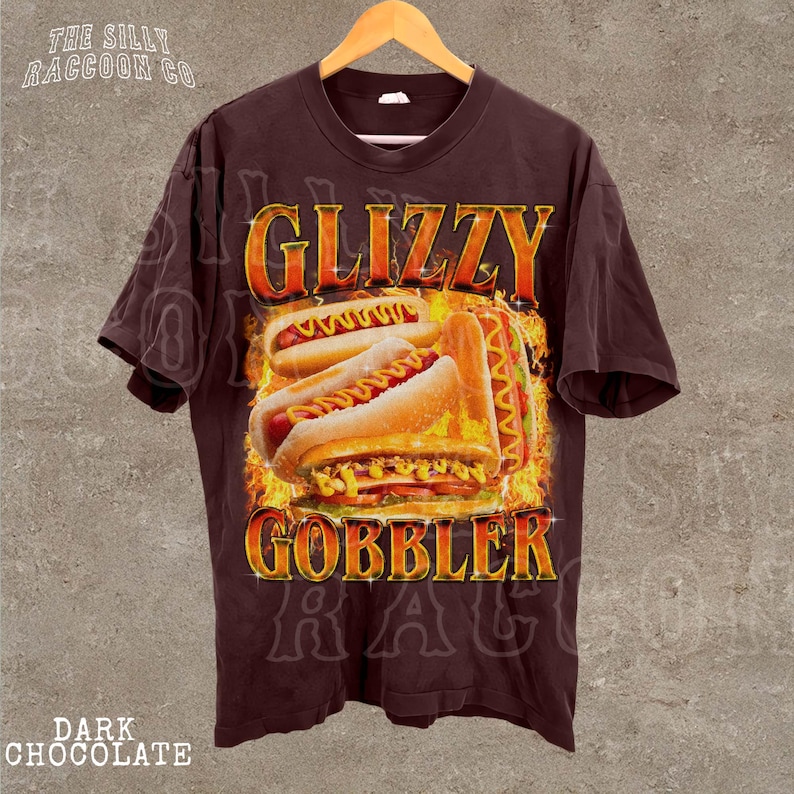A dark brown t-shirt with a graphic design featuring a hot dog and the text "GLIZZY GOBBLER" prominently displayed.