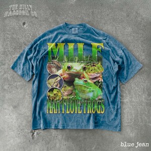A blue t-shirt with a graphic design featuring multiple images of frogs.