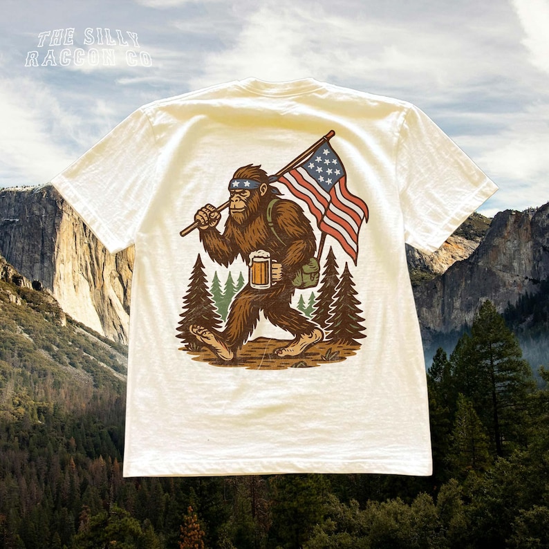 a t - shirt with a picture of a bigfoot holding a flag