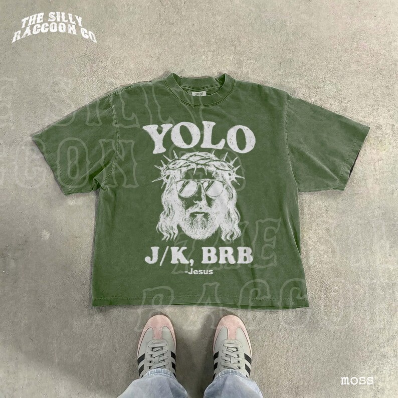 A pair of sneakers and a green t-shirt with a graphic design featuring a man's face wearing sunglasses and a crown, along with the text "YOLO J.K. BRB Jesus".