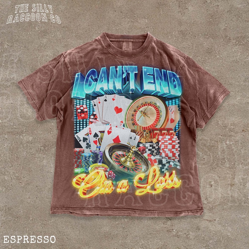 A t-shirt with a graphic design featuring casino elements, including a roulette wheel, playing cards, and poker chips, along with the text "I CAN'T END" and "On a Loss".