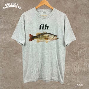 A gray t-shirt with a graphic of a fish and the word "fish" printed on it.