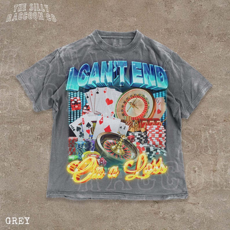 A grey t-shirt with a graphic design featuring various casino-related elements, including playing cards, a roulette wheel, and stacks of chips. The text on the t-shirt reads "I CAN'T END" and "On a Loss".