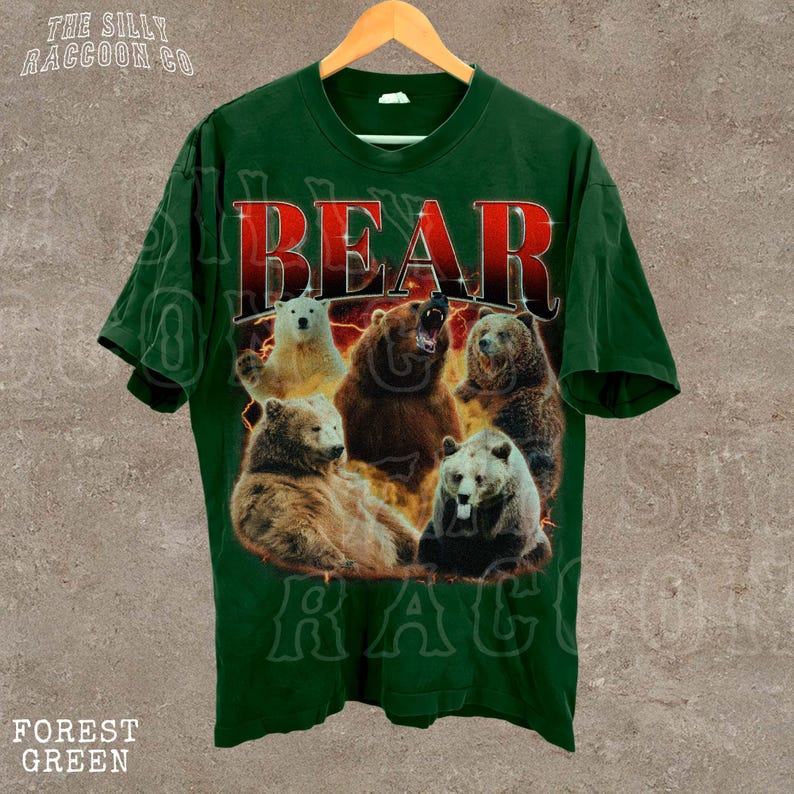 A green t-shirt with a graphic design featuring a group of bears, including a large bear with its mouth open.