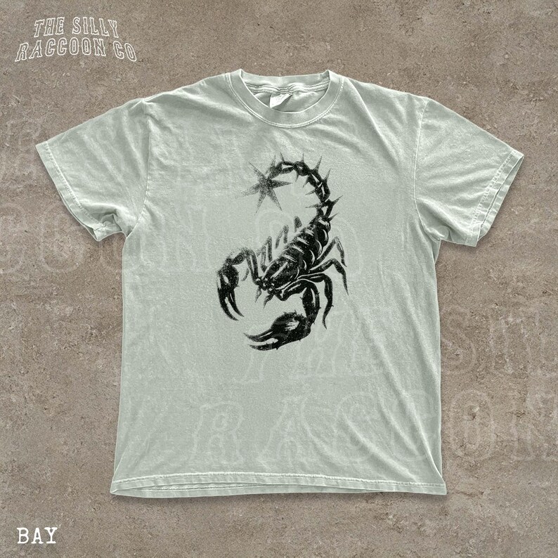 A white t-shirt with a black graphic of a scorpion printed on it.
