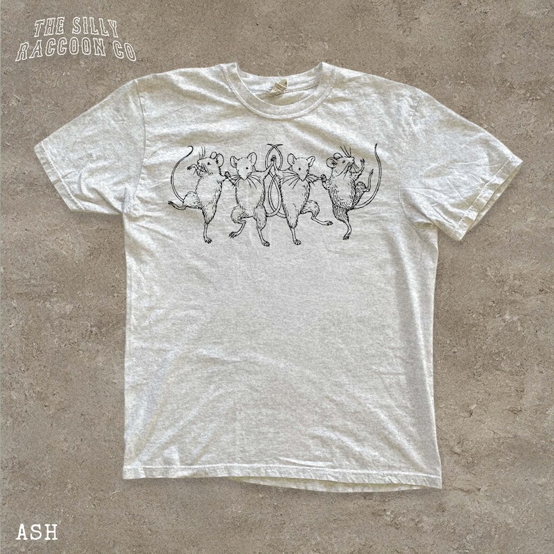 A white t-shirt with a graphic design of five mice standing on their hind legs, arranged in a line.