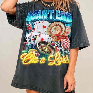 A woman wearing a black t-shirt with a graphic design featuring casino elements, including a roulette wheel, playing cards, and stacks of poker chips.