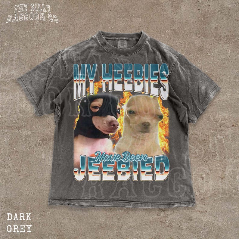 A t-shirt with a graphic design featuring two dogs, one black and one tan, with flames and text overlaying the image.