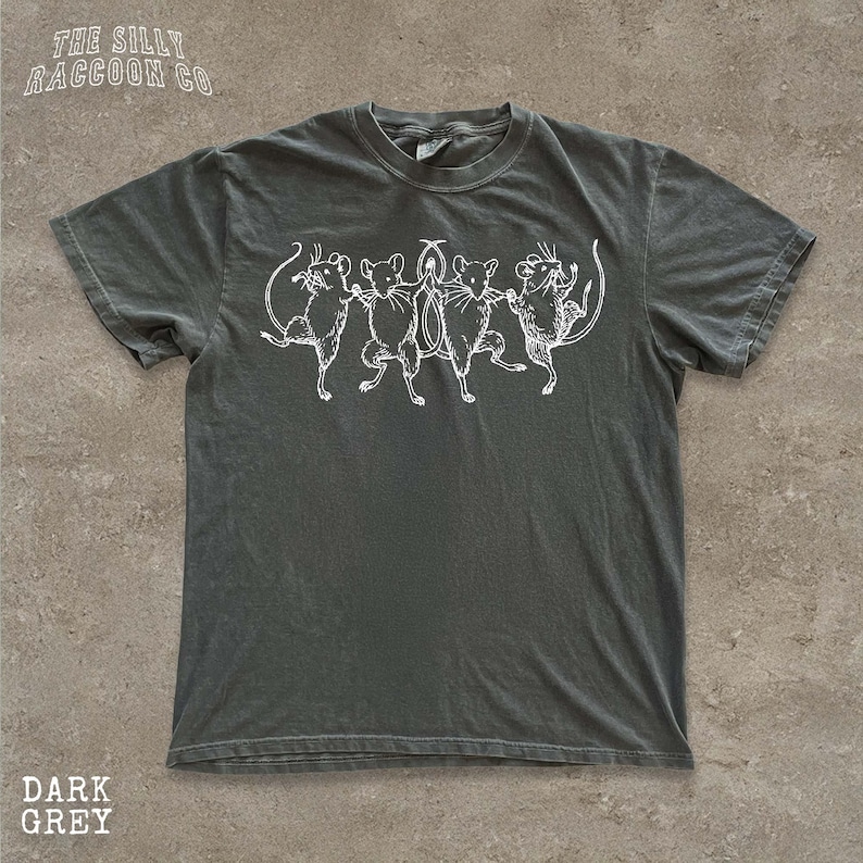 A gray t-shirt with a graphic design of five cartoon mice dancing together.