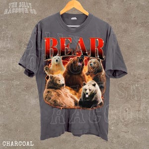 A gray t-shirt with a graphic design featuring a group of bears, including a bear with a growling expression, all surrounded by flames.