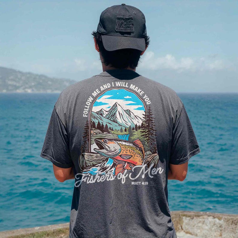 a man looking out at the ocean from a cliff